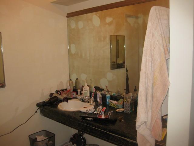 27:  Here is the exposed bathroom vanity. This is just outside the master bath where there is a small pedistal sink, and opposite lauren walkin.