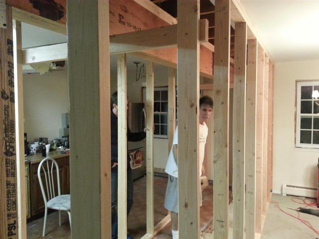 104:  We also had to rip down a 2x4 to widen up the top plate of the original wall. We put the extra meat on the side of the house that carries the second story - Same as the beams in the basement were. We made a cradle out of 2x4s to rest the 16 foot beam on top of. Then we shimmed it up against the existing top plate as tight as we could without risking the cradles failing.