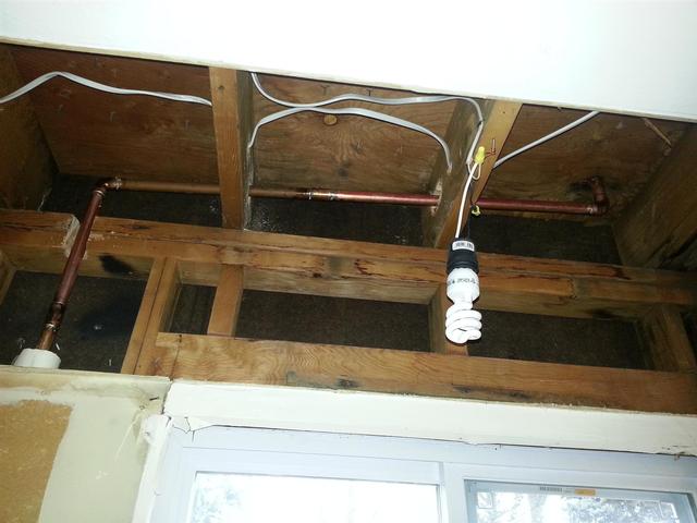 124:  There was a heat pipe running through the soffit leading to the office above. We cut holes in the joists to run it through the floor. I am under the impression that you can cut up to  1/3 the joists width out of the middle, as long as you have 2"
