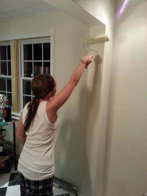 186: Lauren rolls on the very first paint on the stub wall covering the beams post.  