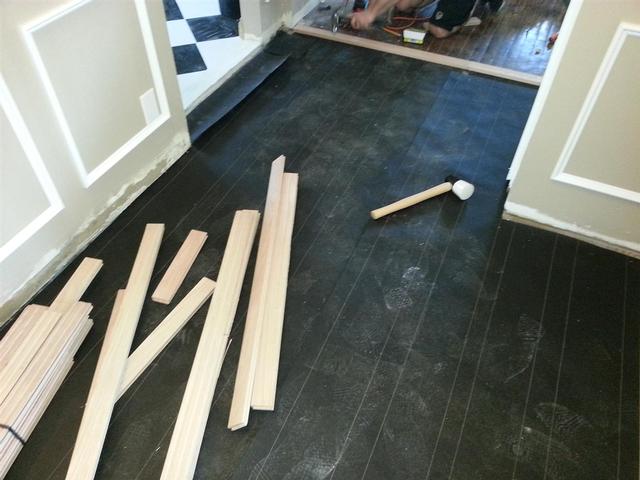 229: Tar paper goes down as a vapor barrier.  You can see my buddy in the background face nailing the two perpendicular rows that divide the rooms.  Thanks again for the help this weekend, Nick.