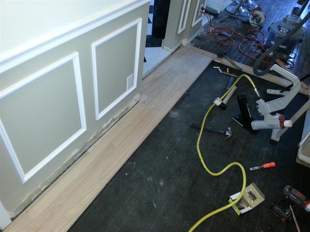 230: The first couple rows need to be face nailed, since you cant fit the floor nailer into position yet.    We will countersink the nail heads and fill with wood putty before sealing.    The subsequent rows can be toe nailed in above the tongue, but its not as strong as face nailing.