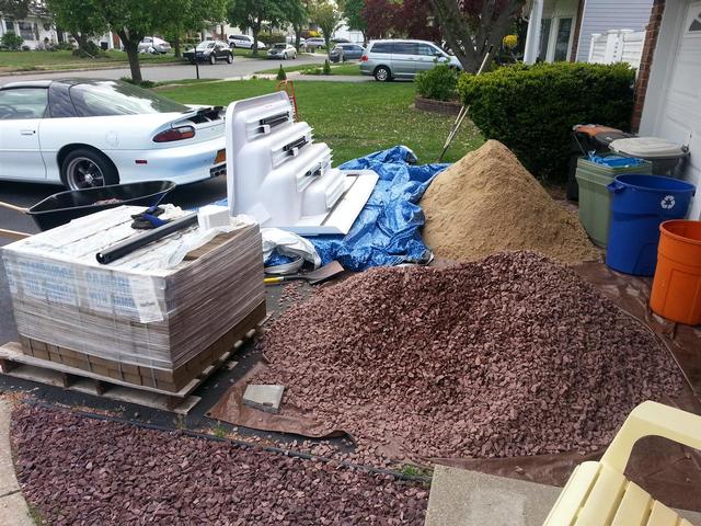 245: Got a few deliveries today.  Got a pallet of pavers, a yard of crushed 3/4 red stone for the front beds, and a yard of fine mason's sand to regrade the pool.  We also got our new pool stairs in.  The bill of lading read 293 Lbs, but half of that must have been the pallets and packaging.