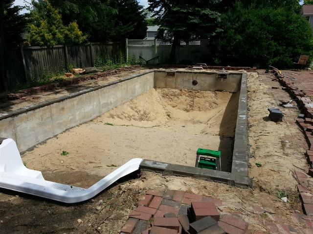 254: 500+ pounds of mortar later, and we have the concrete block down.  We coated the existing walls with a slurry of mortar and concrete adhesion additive to help the bond to the 30 year old concrete.  It all seems pretty solid, thoug things could stand to be a little straigher and more level.  If I were to do it over, I would probably just use thinset between the walls and block, that way things woudl have been a little more level.