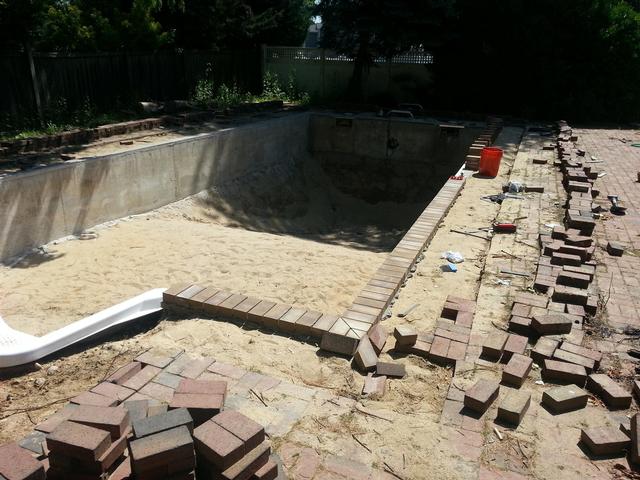266: With the liner track glued, drilled and screwed down again, we can start laying the pavers down to form the pool coping.