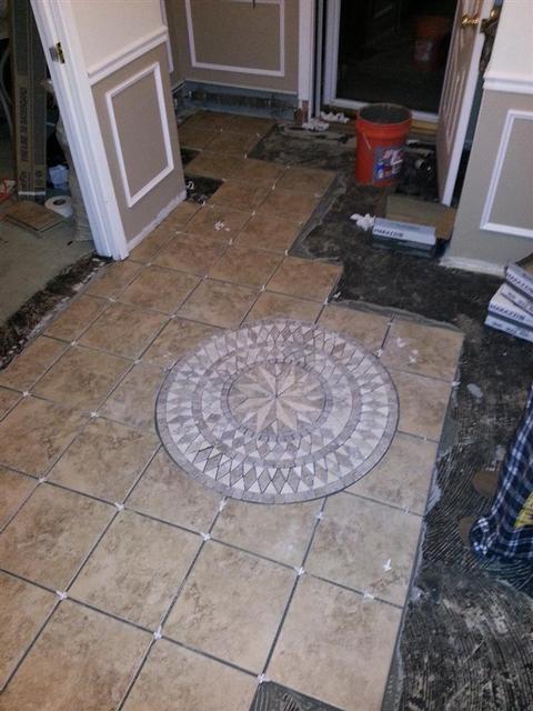 318: The medallion is in place.   You can see some thinset coming up between the tiles.  