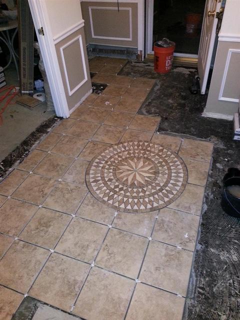 319: We leveled the mosaic down with the grout flat, and then sponged off as much excess thinset as possible.  Unfortunately Ill need to address this after the thinset hardens.  