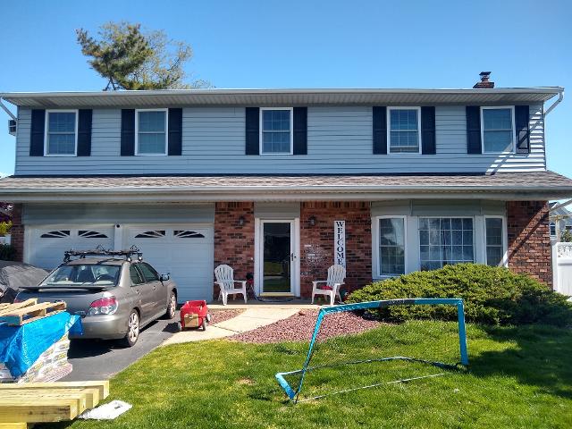 413: Not a great pic, but we just got the delivery of all the supplies for the porch.   You can also see the original brick, and the Juniper bush.