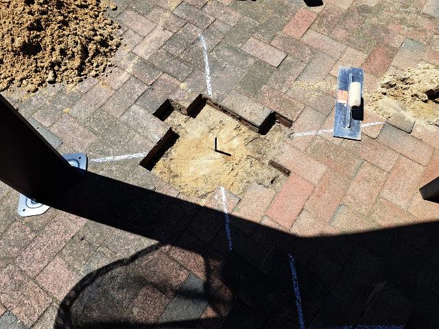 442: We put the sand back over the concrete footings and made sure the threaded rod aligned with the scribed marks.