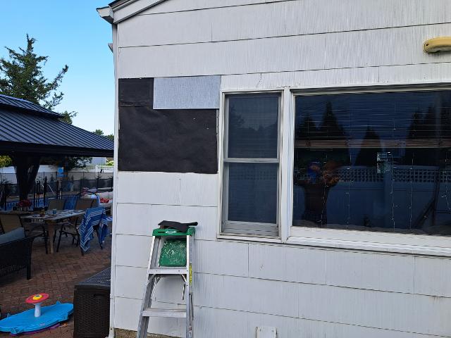 403: The den is tar papered, and the first shingle goes up.